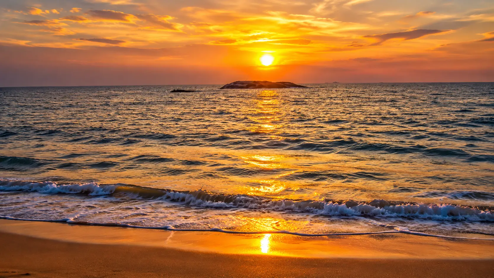 Golden sunset over Malpe Beach shoreline